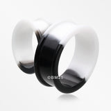 A Pair of Black and White Duo Tone Flexible Silicone Double Flared Tunnel Plug